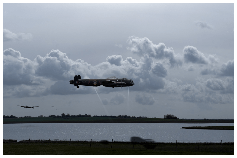 RAF Lancasters at low level over moonlit lake